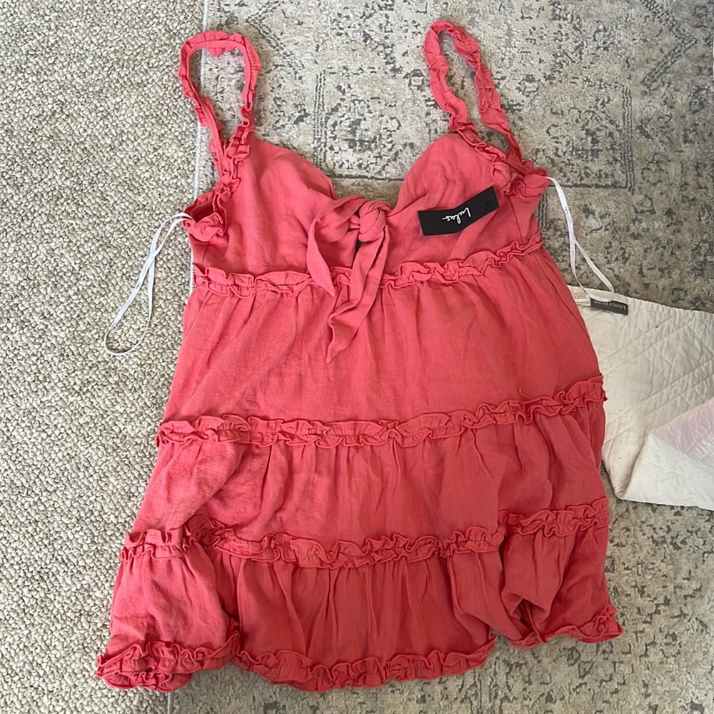 Lulus coral (pink) color mini dress. Flowy fit. Ruffle style. Flattering bust